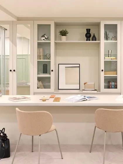 The central workstation at our Furbishy HQ, designed for team collaboration. The long desk provides ample space, while the glass-fronted cabinetry behind it offers stylish storage and display for material samples and decor.