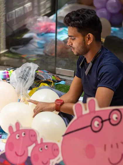 Behind the scenes of a Peppa Pig party. Our decor partners and staff work meticulously, here seen preparing the balloon arrangements.