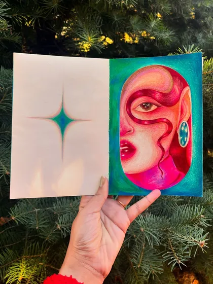 Holding the sketchbook with the red-haired portrait study.