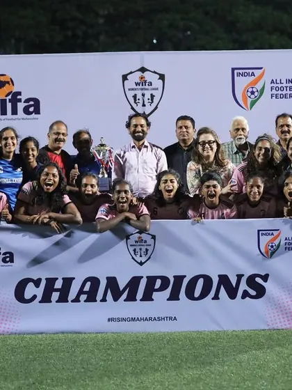 The moment of triumph. Our team and staff celebrating with the "CHAMPIONS" banner after winning the WIFA Women's League.