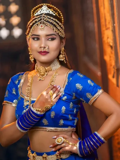 A close-up of the royal blue themed look, highlighting the intricate details of the choker, nose ring, and the multi-layered headpiece.