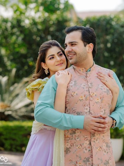 A lovely couple portrait. The bride's fresh and vibrant makeup complements the colorful and festive decor of the Mehendi ceremony.