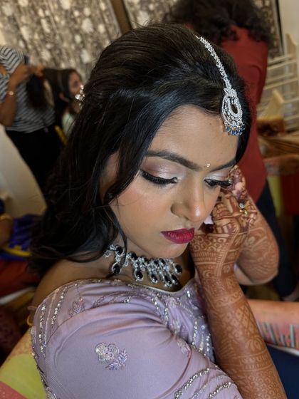 A close-up of Isha's reception makeup. Notice the soft shimmer on the eyes and the flawless, matte finish on the skin, designed to look perfect in every photograph.