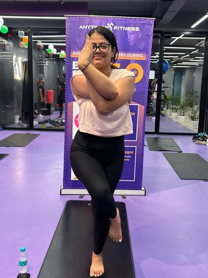 This member demonstrates a strong and stable Eagle Pose, a result of consistent practice and dedication in our yoga classes.