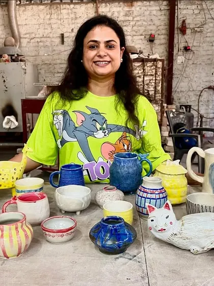 Look at that smile and the amazing collection of first-time creations! From a quirky cat sculpture to colorful mugs and bowls, this is what pure, unfiltered creativity looks like. This is what my studio is all about.