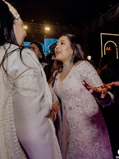 A candid moment of dancing and celebration. The bride's makeup is designed to be sweat proof and long lasting.