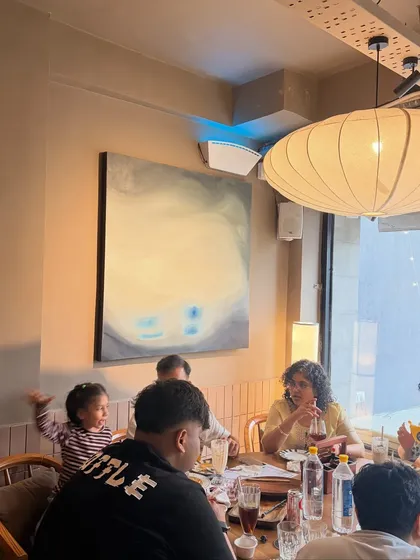 It's amazing to see people enjoying the space around my art. This piece was designed to be a beautiful backdrop for conversations and meals at the cafe.