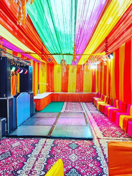 The same tent setup from another angle, showing the colourful seating arrangement and the full length of the venue.