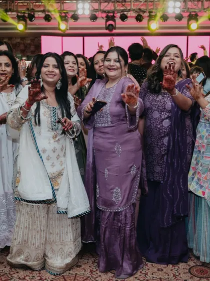 Guests enjoying the music and vibe at the Sufi Night, with their hands adorned with henna.