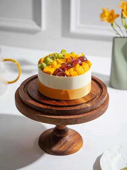Mango mania is going strong at our bakery with this beautiful cake topped with fresh mango, kiwi, and grapes.