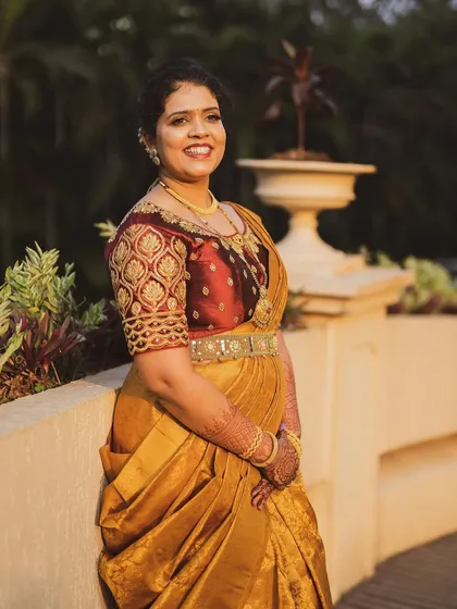 The groom's sister ready for the wedding in a gorgeous gold Kanchipuram saree, which I draped in a modern lehenga style.