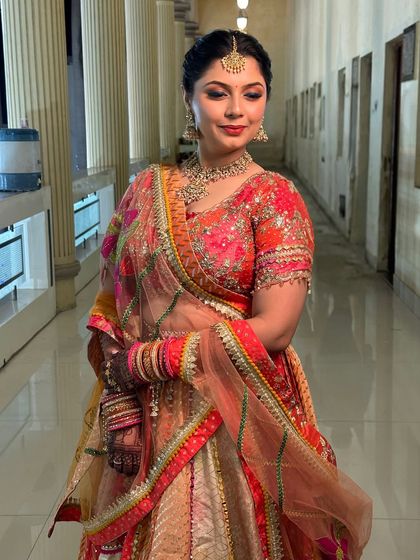 A beautiful portrait of the bride, showcasing the intricate details of her outfit and the flawless, long-lasting makeup.