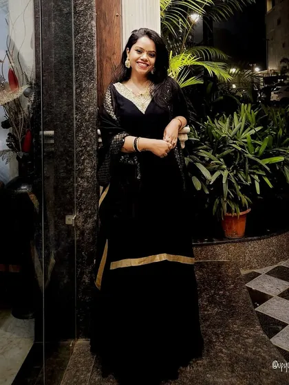 A classic black Anarkali suit with gold detailing, exuding timeless elegance for any formal occasion.