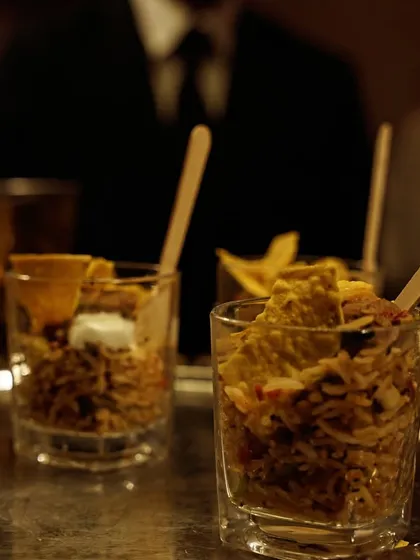 My Mexican Rice is served in individual glasses for a convenient and stylish appetizer. It's a flavorful mix of seasoned rice, beans, and corn, topped with a dollop of sour cream.