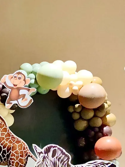 Another angle of the balloon arch, showing the giraffe and zebra cutouts peeking through.