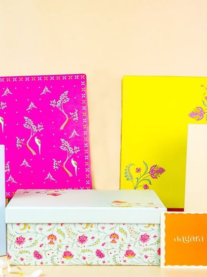 A collection of brightly colored, hand-painted gift boxes and packaging. This type of shot is perfect for a brand that wants to highlight its beautiful and unique packaging.