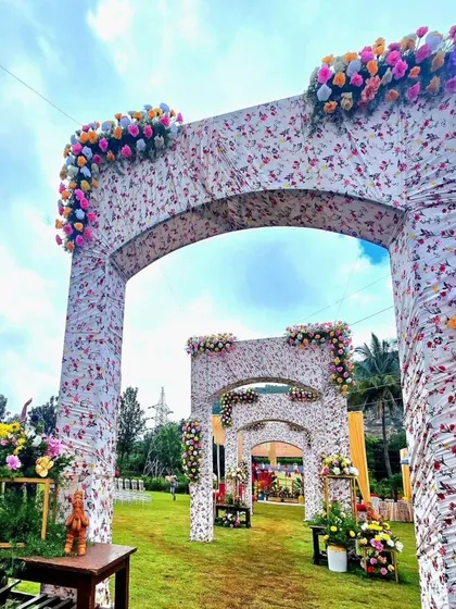 A grand entrance with multiple floral-printed arches. This creates a beautiful and picturesque walkway for guests, perfect for an outdoor garden event.