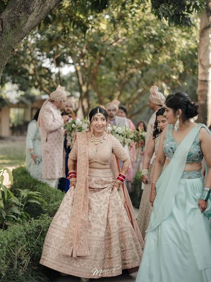 The bride's happy entrance, surrounded by her family and friends, her excitement palpable.