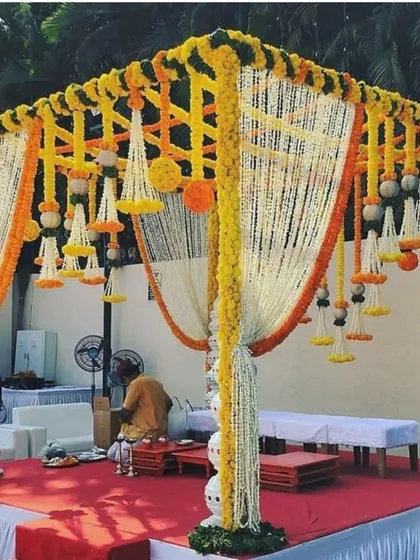 The mandap is the heart of the wedding ceremony, and I ensure it looks perfect. This is an example of a traditional mandap decorated with fresh genda phool and tuberose (rajnigandha) strings, creating a sacred and beautiful space.