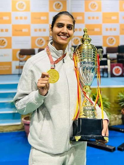 Sonam Rawal with her Gold medal and the championship trophy, qualifying for the All India University Championships.