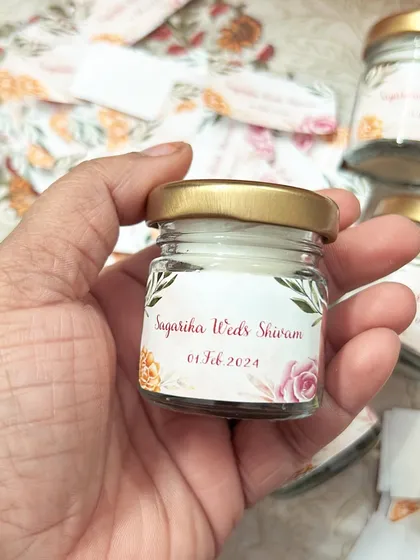 This mini scented candle is the perfect size for a return favor. The label was designed to match the floral theme of Sagarika and Shivam's wedding.