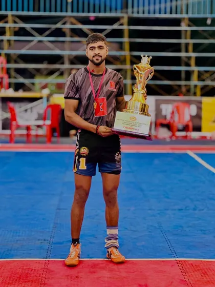 Vicky Bainsla, one of our promising players, holding the trophy after a successful tournament. He was selected for the 50th Junior National Championship.