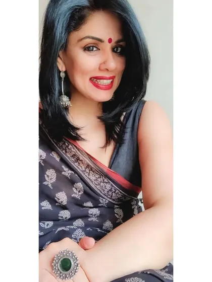 A selfie showing the pop of red lipstick and the silver statement ring against the black printed cotton saree.
