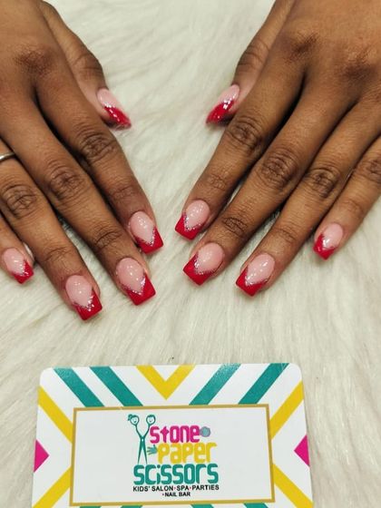 A classic French manicure but with a pop of color. I used a vibrant red for the tips on these short, square nails, adding a tiny bit of glitter for extra sparkle.