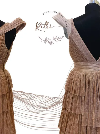 The front and back view of the rose gold gown, highlighting the deep V-back and the structured, modern design.