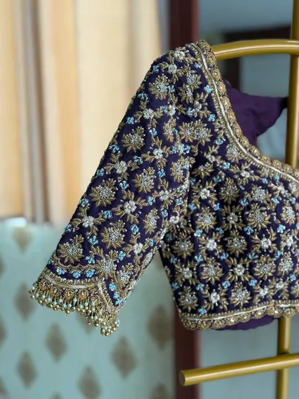 The sheer luxury of a fully hand-embroidered zardosi blouse in a deep aubergine. I use high-quality velvet and intricate floral patterns to create pieces that feel truly royal and are perfect for a grand bridal trousseau.