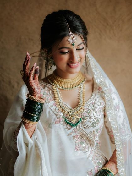 A soft, serene portrait. The makeup is flawless and enhances her natural features.