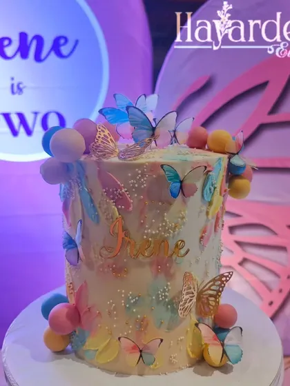 A stunning butterfly-themed cake, perfectly matching the party's decor. I can coordinate with your baker to ensure a cohesive look.