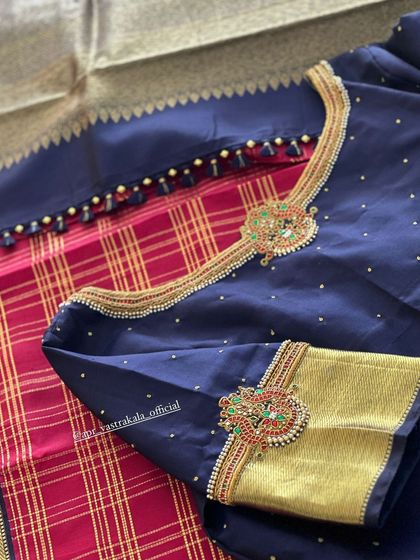 A close-up of the jewellery-inspired motifs on the navy blue blouse.