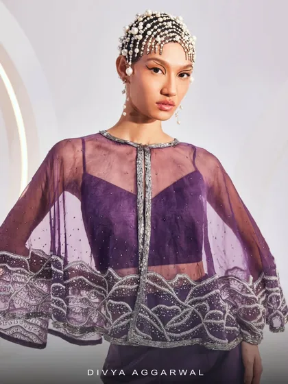 A detailed shot of the ZOEY Cape Set, focusing on the craftsmanship of the embellished organza cape.