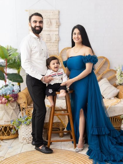 A growing family. This beautiful portrait captures a maternity moment with the older sibling, celebrating the anticipation of a new arrival.