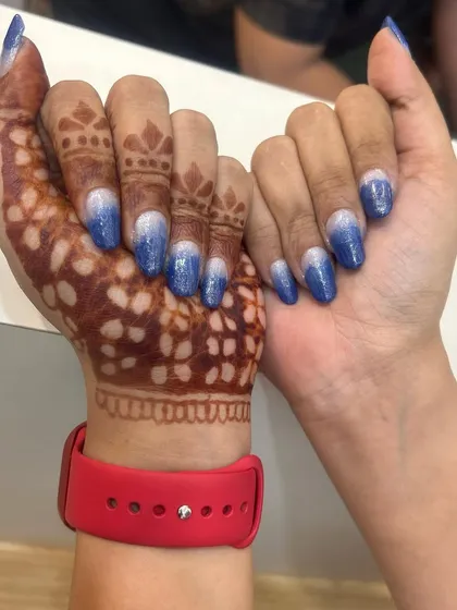This client wanted something special to go with her henna. I created this sparkling blue and silver ombre design on her natural nails, which beautifully complements the intricate mehndi art.
