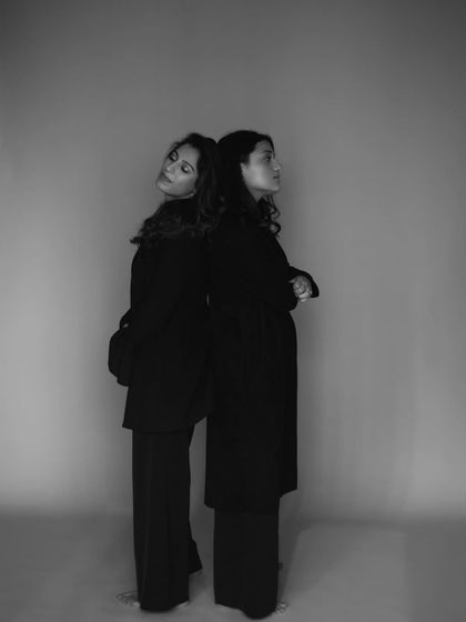 A more posed shot of two friends standing back to back. This composition speaks to both their individuality and their deep connection.