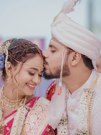 A sweet and intimate moment between the couple. The groom's kiss on the forehead is a classic wedding shot, and our bride looks absolutely beautiful.