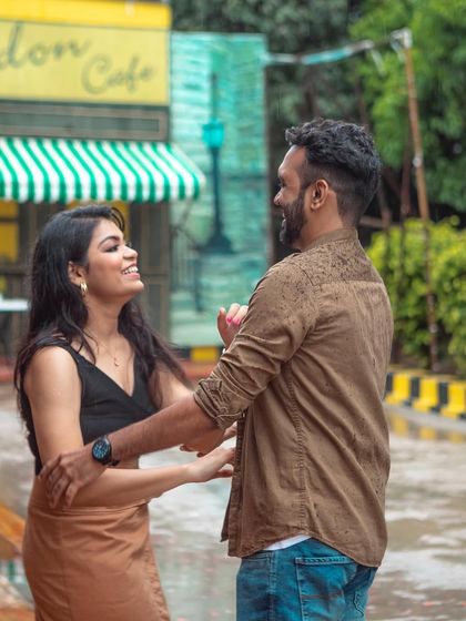 A playful and interactive shot of the couple dancing in a vibrant, outdoor location, showcasing their fun-loving personalities.
