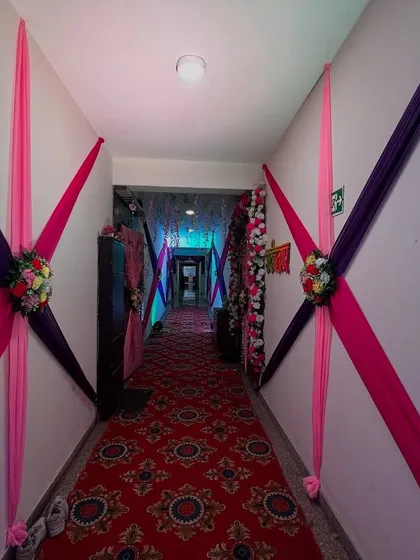The same hallway decorated with pink and purple drapes, showing how the look can be changed to match different color themes.