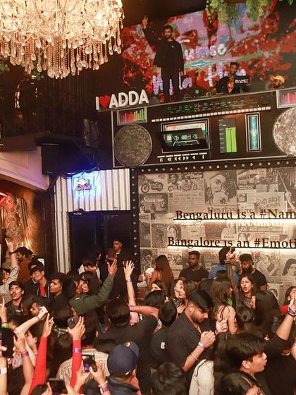 The whole club with their hands up. A night for the books at Bombay Adda.