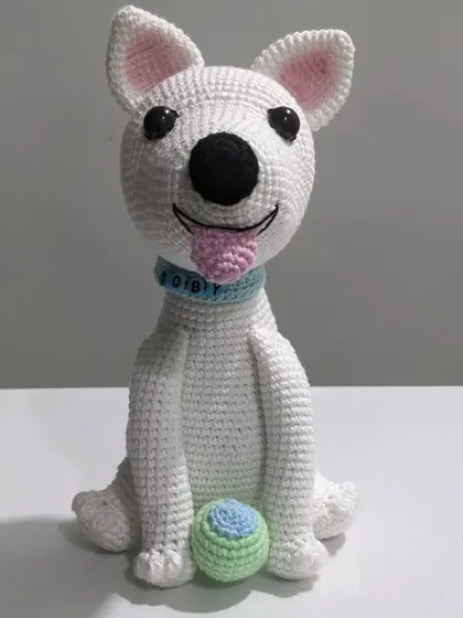 A custom crochet portrait of a beloved pet dog named Toby. I captured his happy expression, floppy tongue, and even included his favorite little ball to make this handmade plushie extra special.