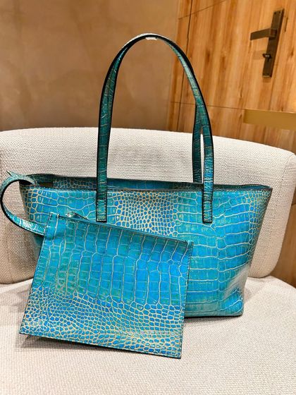 Our Basic Tote in a stunning marine blue croc-print. It comes with a detachable zipper pouch for extra storage of your mini essentials.