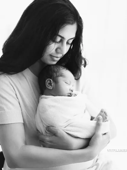 A mother's embrace. This delicate, high-contrast black and white portrait captures the emotional, warm, and loving bond between a mother and her newborn.