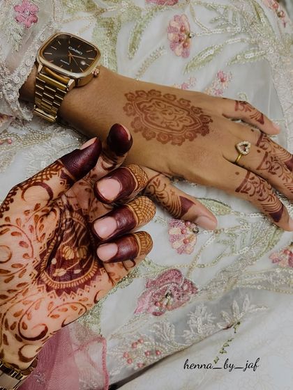 A beautiful shot showing two different henna designs, one fresh and one with a mature, dark stain. Perfect for a party or wedding.
