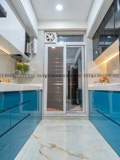 This angle highlights the smart storage solutions, including pull-out wicker baskets for vegetables next to the refrigerator, ensuring everything has its place.