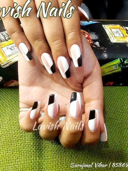 A bold, color-blocked design in black, white, and sheer pink on long coffin nails.