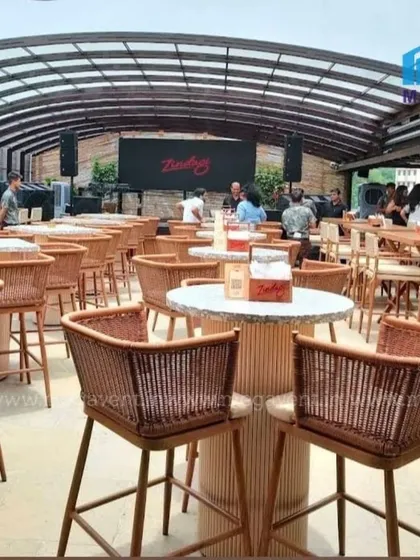 This retractable roof transforms a restaurant's outdoor seating area, ensuring business is never interrupted by weather. The system is shown here fully extended, covering the entire space.