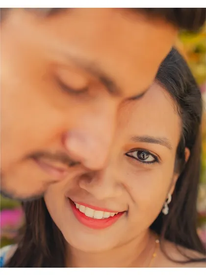 An artistic portrait with a tight crop, focusing on her expressive eyes and smile. This style of shot adds variety and intimacy to your final photo gallery.