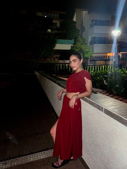 Posing in my red vacation outfit. The color is bold and confident, perfect for making memories on a trip.